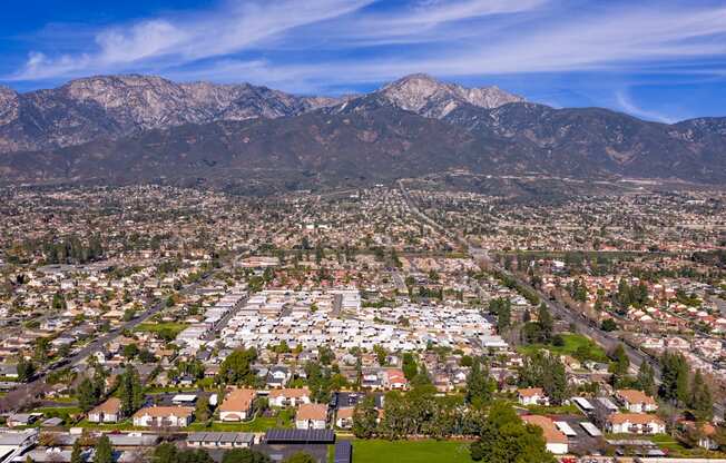 A cityscape with houses and mountains in the background.