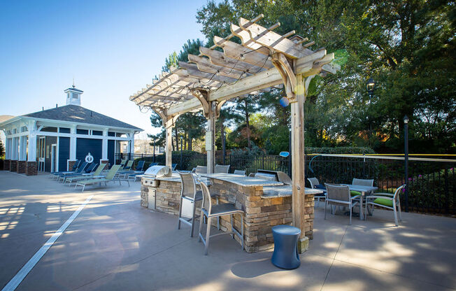 a patio with a table and chairs and a pergola