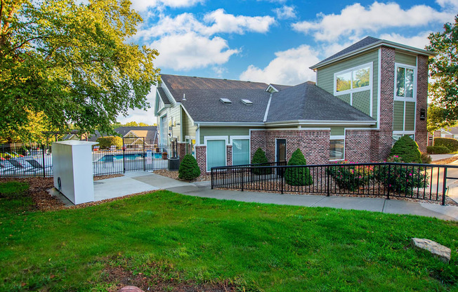 A house with a grey roof and a white fence.