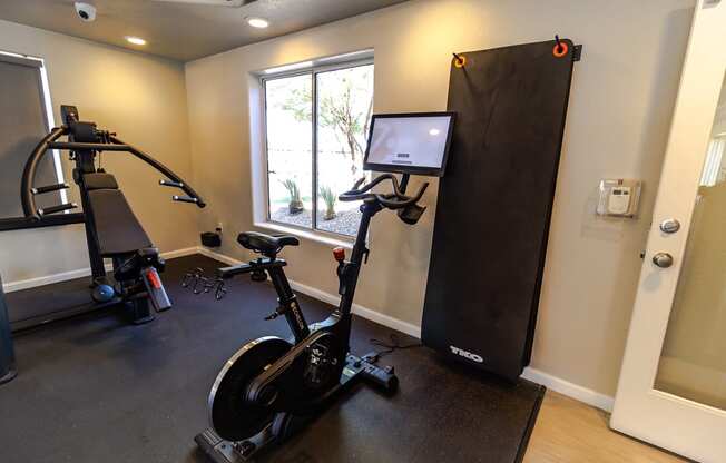a home gym with an exercise bike and a computer