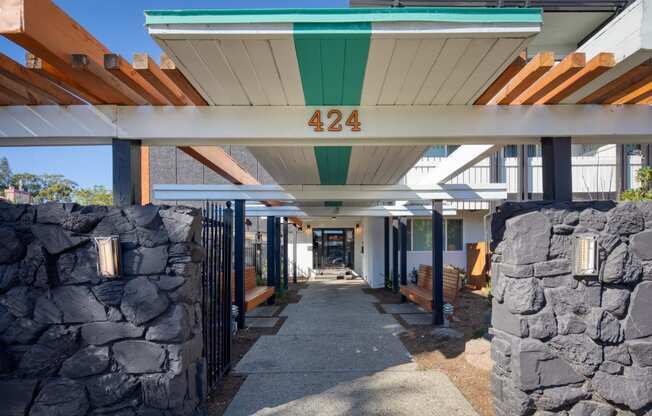 a view of the front of the building with stone walls and awnings