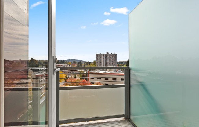 A glass door with a view of the cityscape outside.