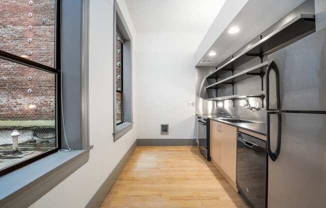 a kitchen with stainless steel appliances and a large window