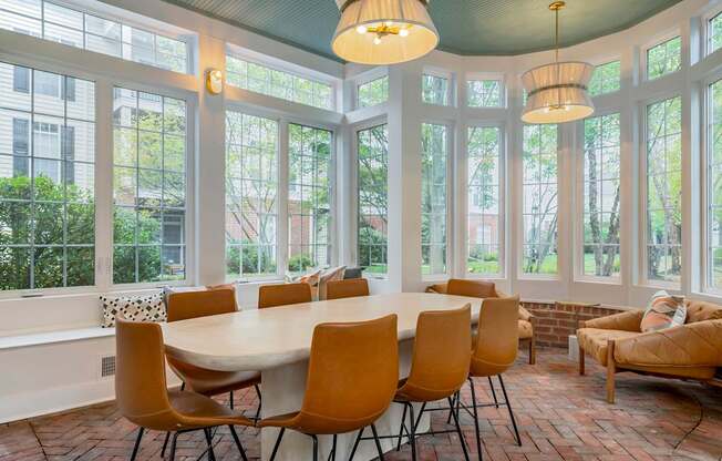 A dining room with a round table and chairs.