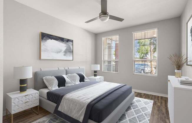 A bedroom with a large bed and a ceiling fan.