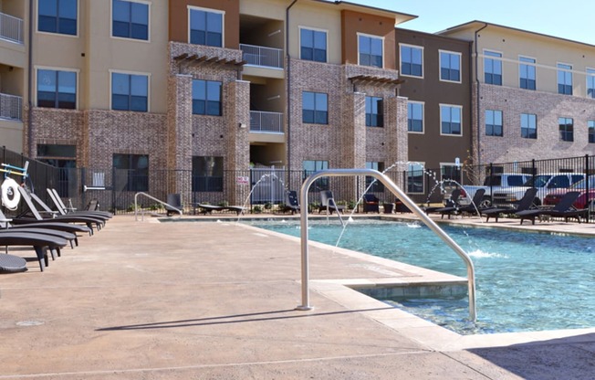 a swimming pool with a building in the background