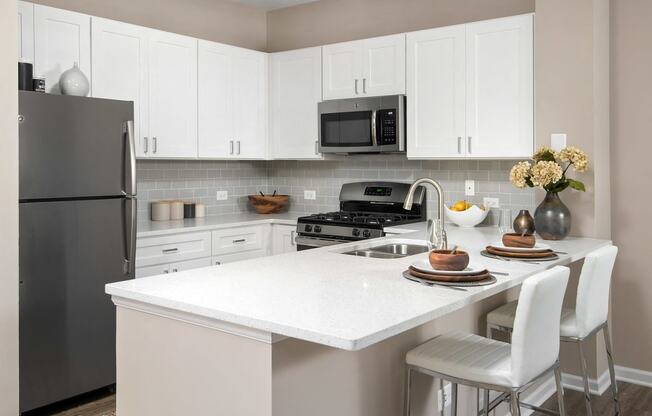 803 Corday at Naperville - Modern Kitchen with White Countertops, Sleek Cabinets, and Stainless Steel Appliances