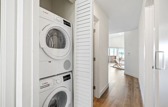 a front loading washer and dryer in a white laundry room