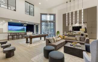 an open concept living room and dining room with a pool table and foosball table