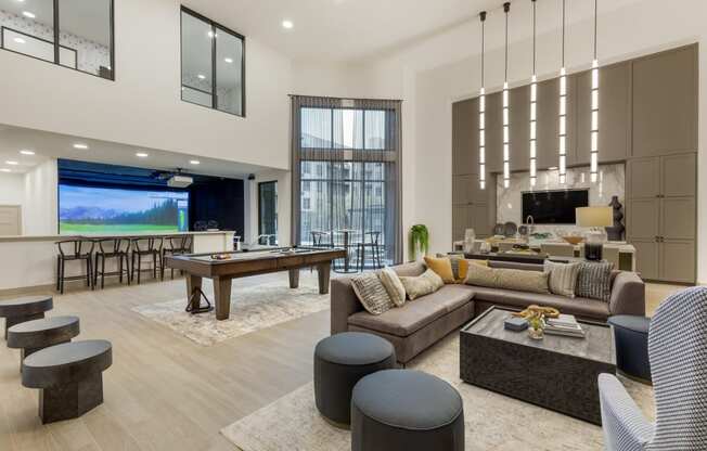an open concept living room and dining room with a pool table and foosball table