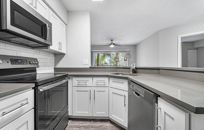 a white stove top oven sitting inside of a kitchen