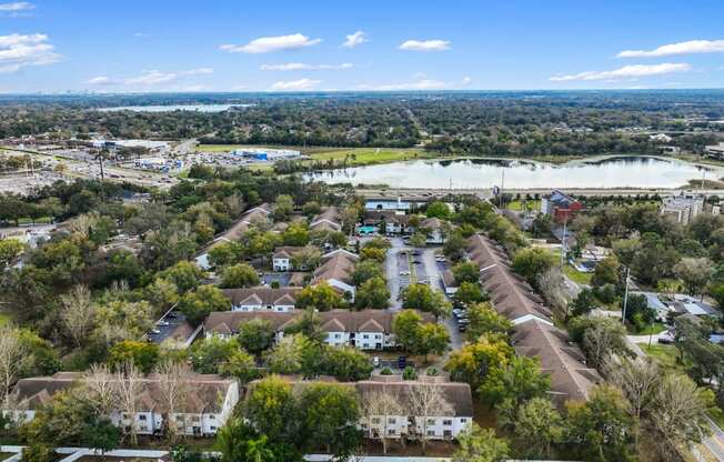 an aerial view of a neighborhood with houses and a lake