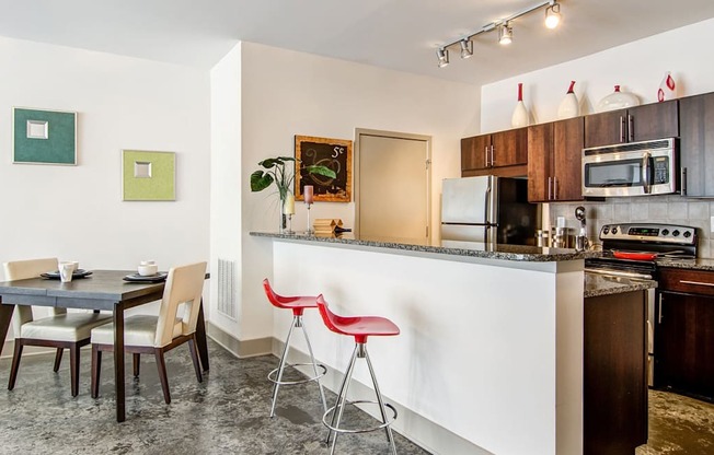 a kitchen with a bar and a dining table