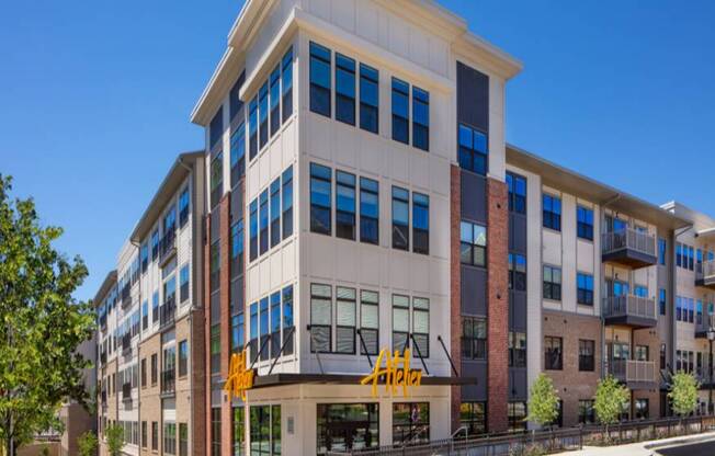 A modern multi-story building with a mix of brick and glass windows.