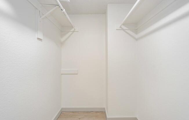 A white room with a wooden floor and white walls.