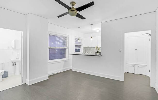 A spacious room with a ceiling fan and a window.