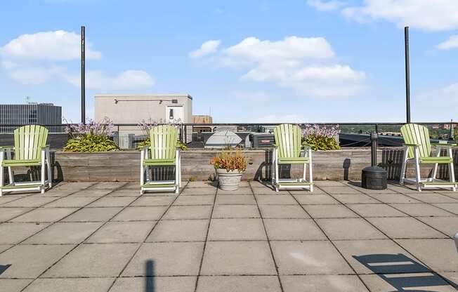 the roof terrace has several chairs and plants on it