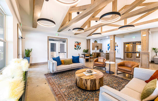 a living room with couches and chairs and a coffee table at The Parker Austin, Pflugerville, TX, 78660