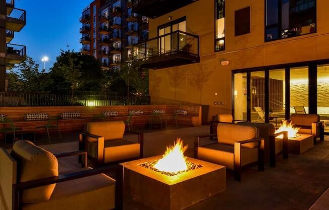 outdoor courtyard at night with firepit and seating