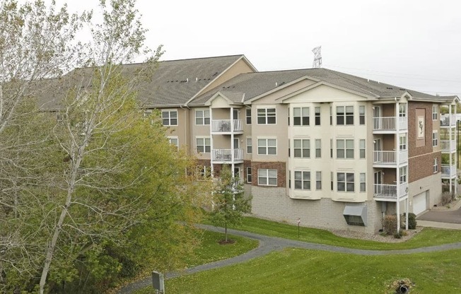 Apartment complex with a green lawn in front.