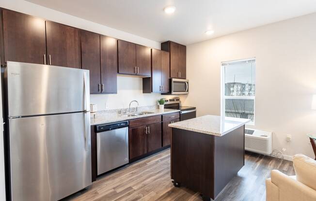 a kitchen with stainless steel appliances and wooden cabinets