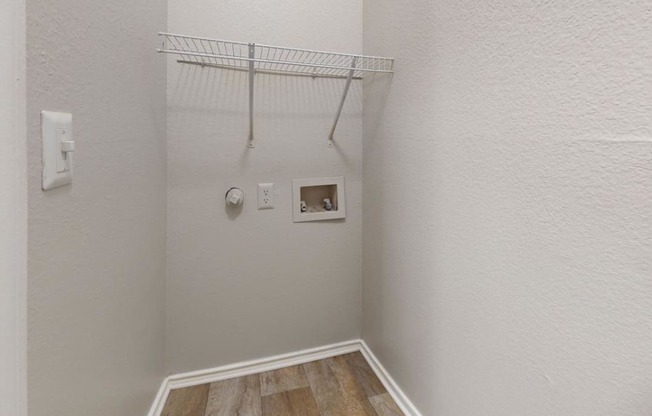 a small bathroom with a shower and a rack on the wall