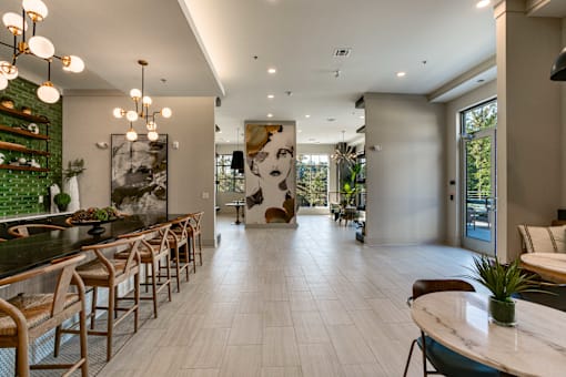 a large room with a bar and tables and chairs