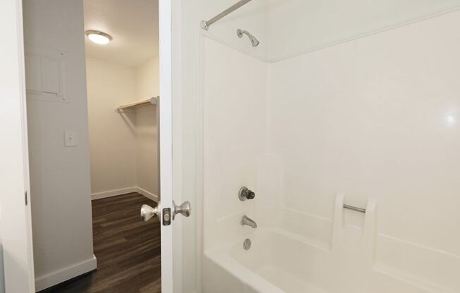 a bathroom with a white tub and a white shower curtain at Bennett Ridge Apartments, Oklahoma City, OK