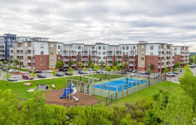 an image of an apartment building with a playground