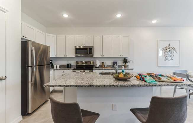 Boatman Hammock Townhomes in Lake Worth, FL photo of a kitchen with stainless steel appliances and a granite counter top