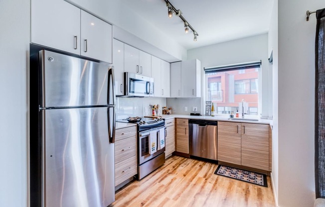 a kitchen with stainless steel appliances and white cabinets