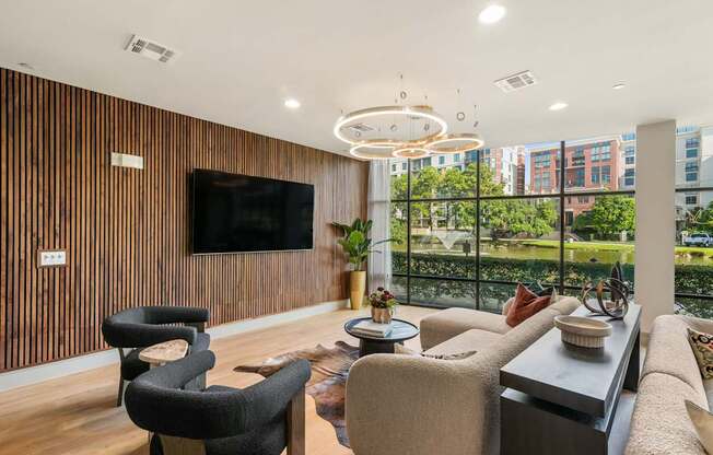 A modern living room with a large flat screen TV mounted on the wall.