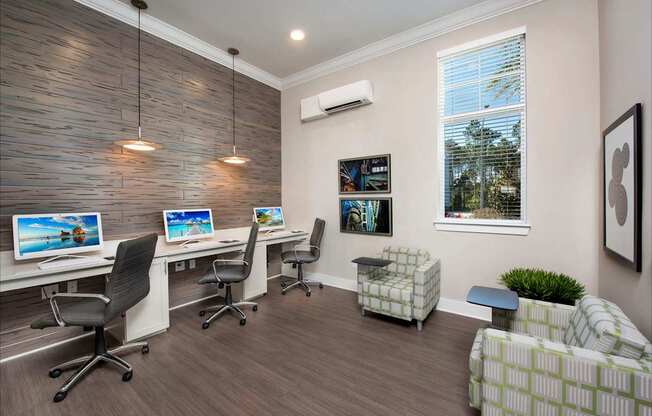 A room with a desk, chairs, and a couch.