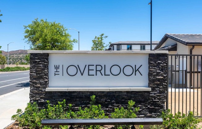 A sign that says "The Overlook" in front of a building.