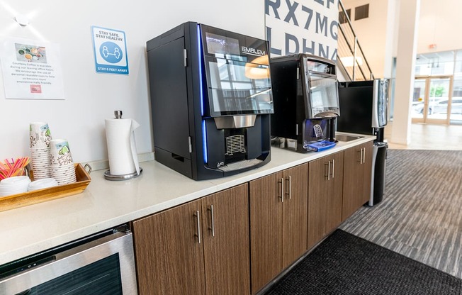 a counter with coffee machines on it in a break room