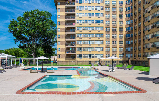 a swimming pool with an apartment building in the background at Parkview Towers, New Jersey, 08107