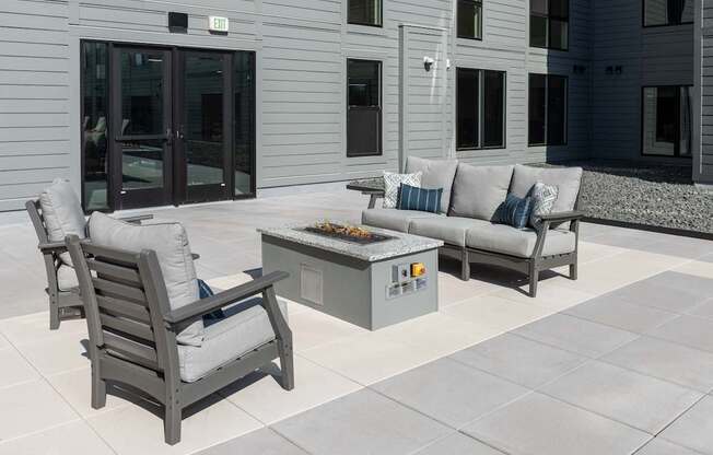 a patio with furniture and a fire pit