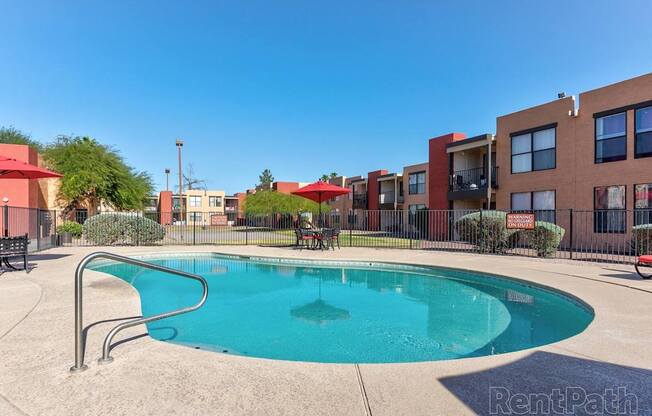 A swimming pool in a residential area with a RentPath logo.
