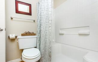 a white sink sitting under a mirror