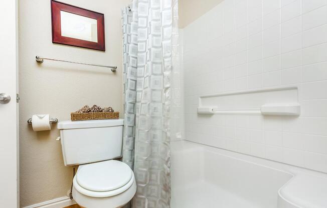 a white sink sitting under a mirror