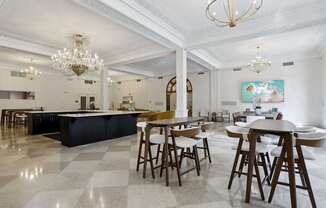 A large, open-plan kitchen and dining area with a checkered floor and wooden furniture.