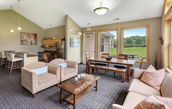 A living room with a couch, chairs, and a coffee table.