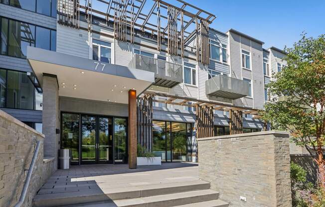 Modern building with a glass facade and a stone entrance at Park77 Apartments, Cambridge, Massachusetts, 02138