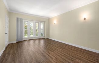 an empty living room with a large window