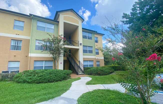 Apartment building exterior surrounded by native landscaping