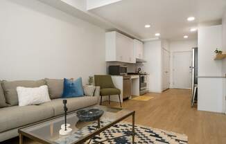 a living room with a couch and a coffee table at The Lucy Boise Apartments, Boise, Idaho