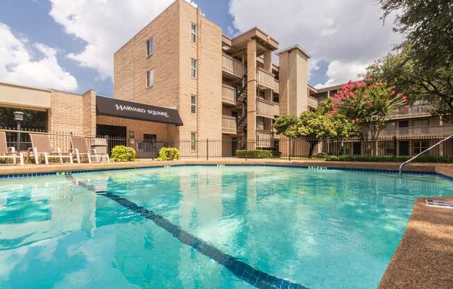 This is a photo of the pool area in the courtyard at Harvard Square Apartments, in the Vickery Meadow neighborhood of Dallas, TX.