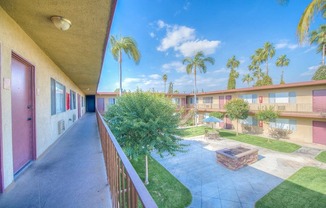 West Covina Apartments for Rent - Courtyard with Lush Landscaping and Walkways Surrounded by Tuscany Villas Apartment Buildings