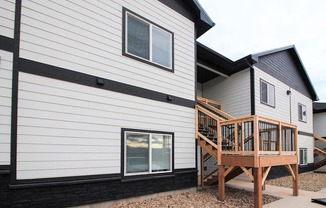 A modern house with a wooden deck.