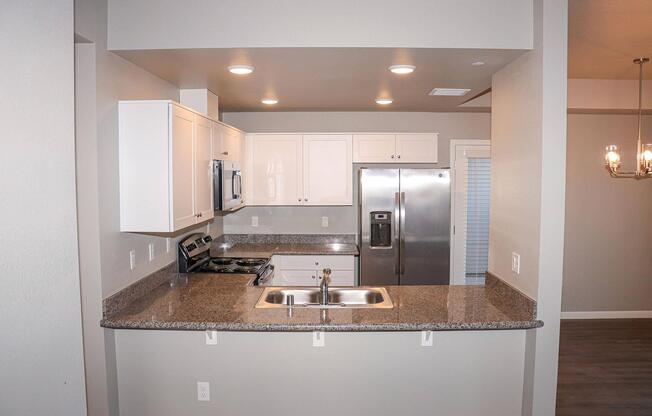 a kitchen with a sink and a mirror